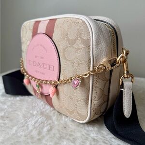 Coach Dempsey camera bag in beige and pink with Coach patch and chain charm